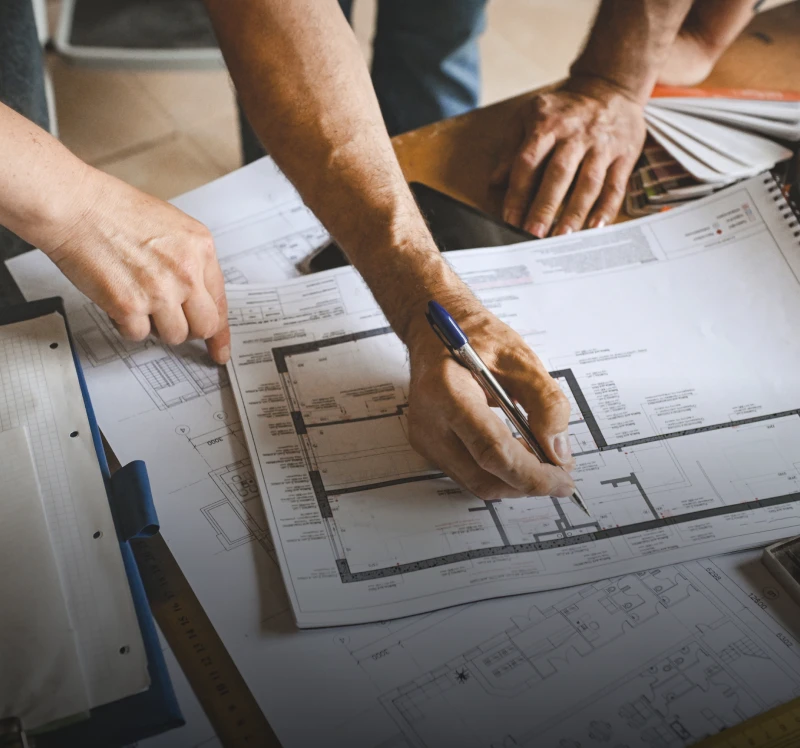 Architects reviewing building plans on table
