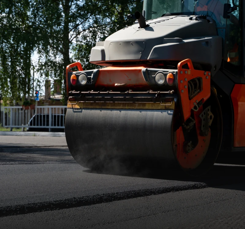 Steamroller in action on street pavement